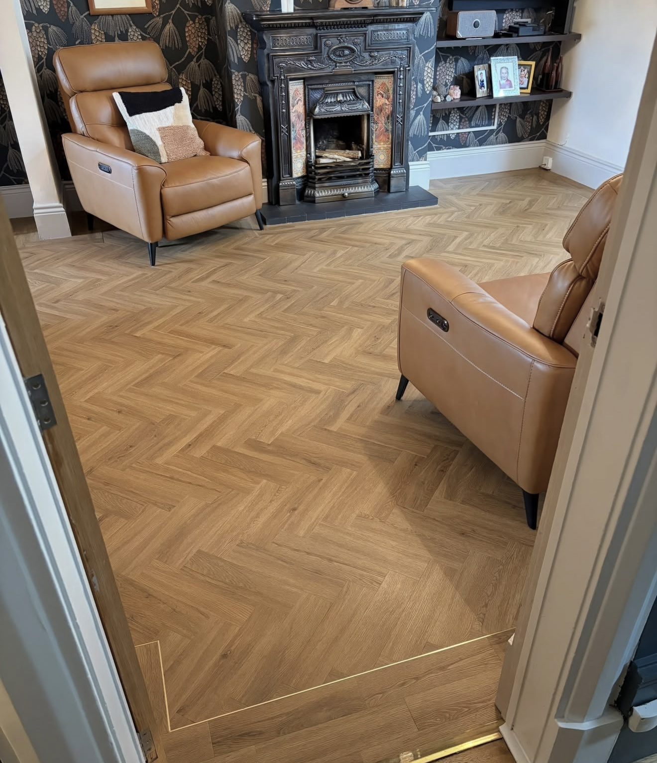Doorway view with brass threshold strip, border and cast-iron fireplace