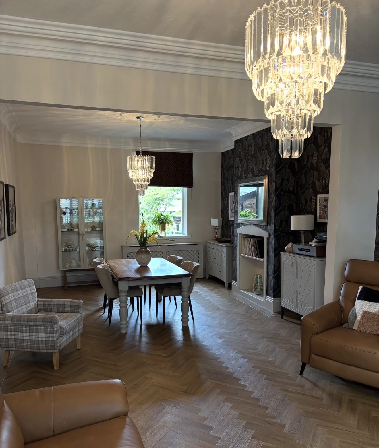 Lounge through to the dining area under crystal chandeliers