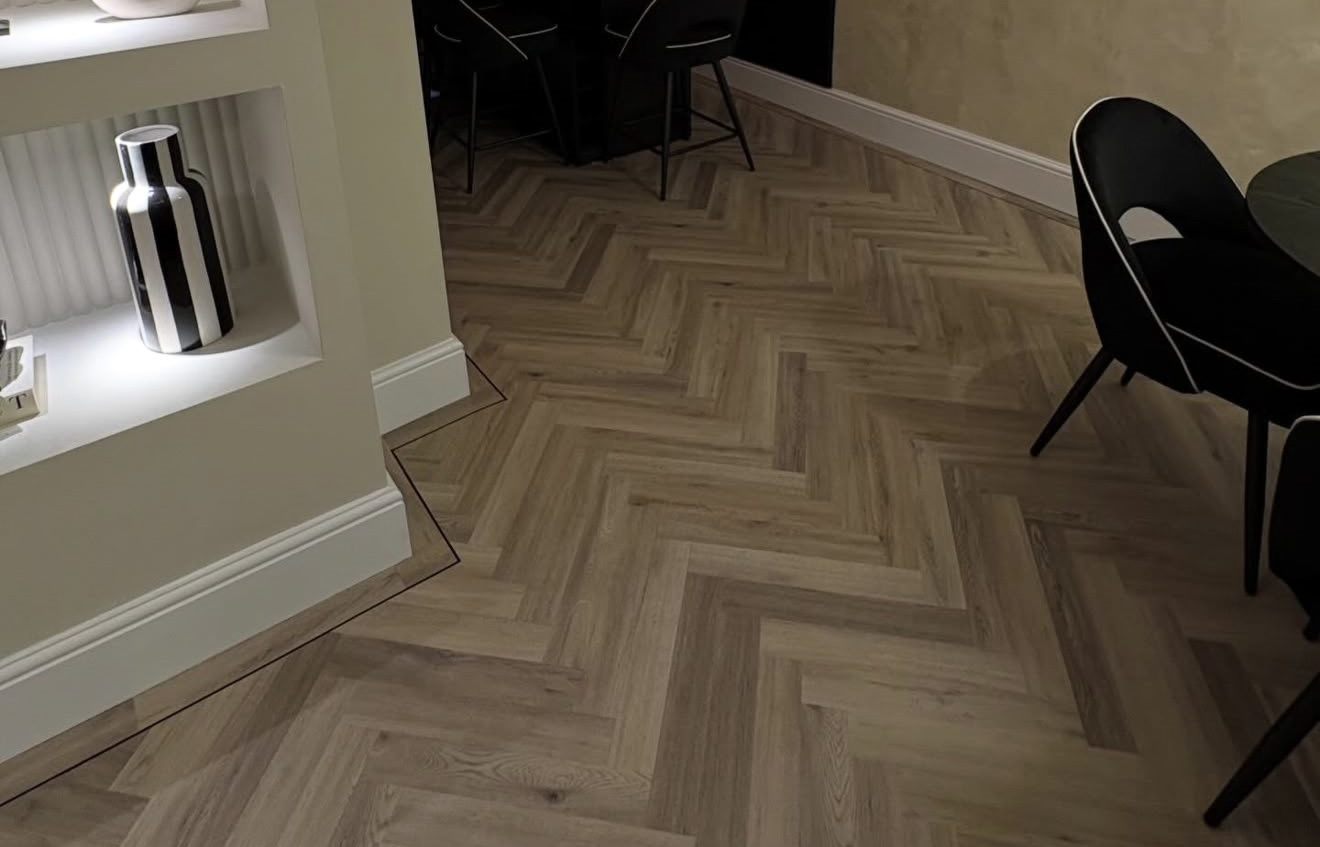 Natural oak herringbone with a border around an alcove